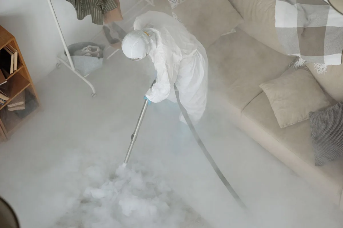 Biohazard cleanup technician in protective equipment, Battlement Mesa, CO